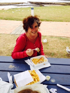 Elbowlass eating fish and chips