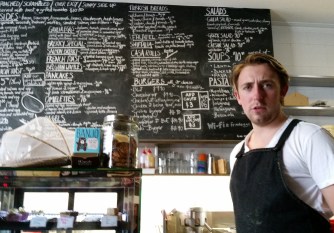 Peter at work in a cafe 