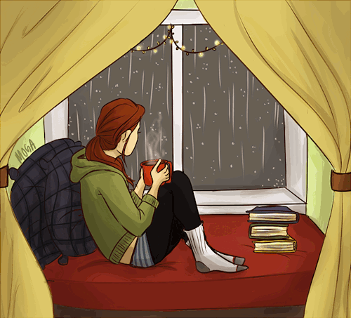 Girl curled up on a window seat with rain outside