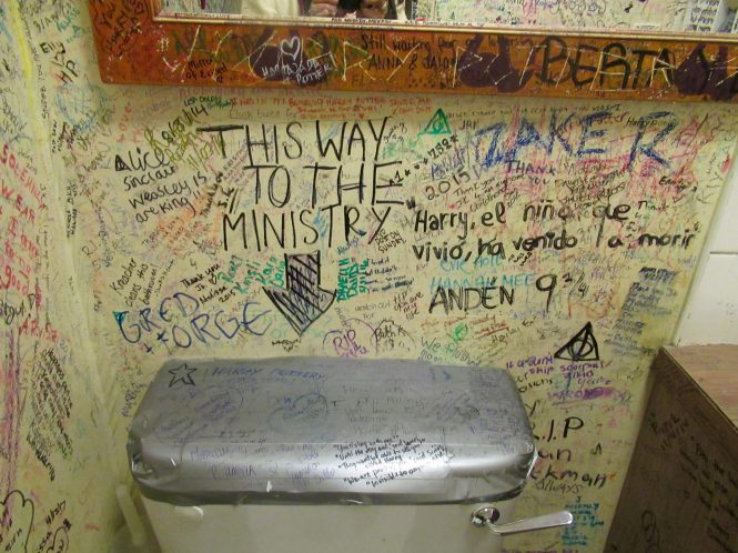 Toilet stall covered with grafitti
