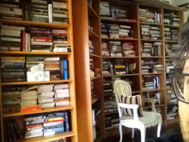 A room full of books with the side of Allyn's face in the corner of the photograph