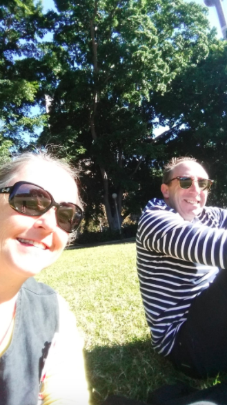 My husband in his blue and white striped long sleeved T-shirt (so French!) with me sitting on the grass in Hyde Park.