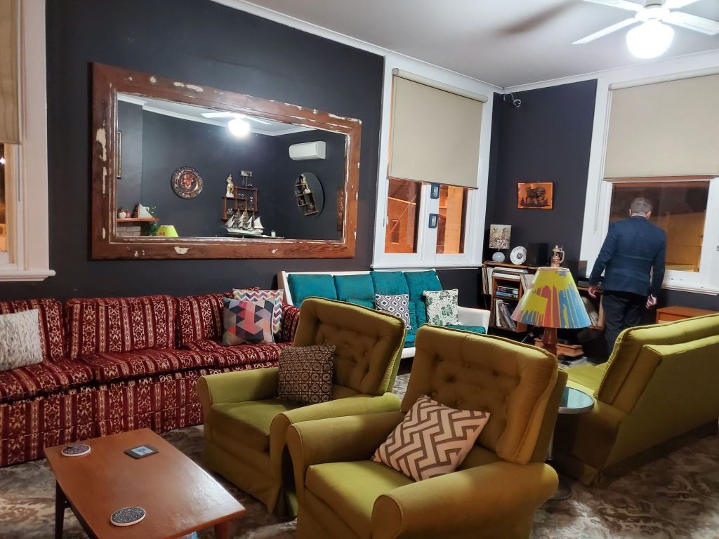 A long view of the lounge room. Husband's back.